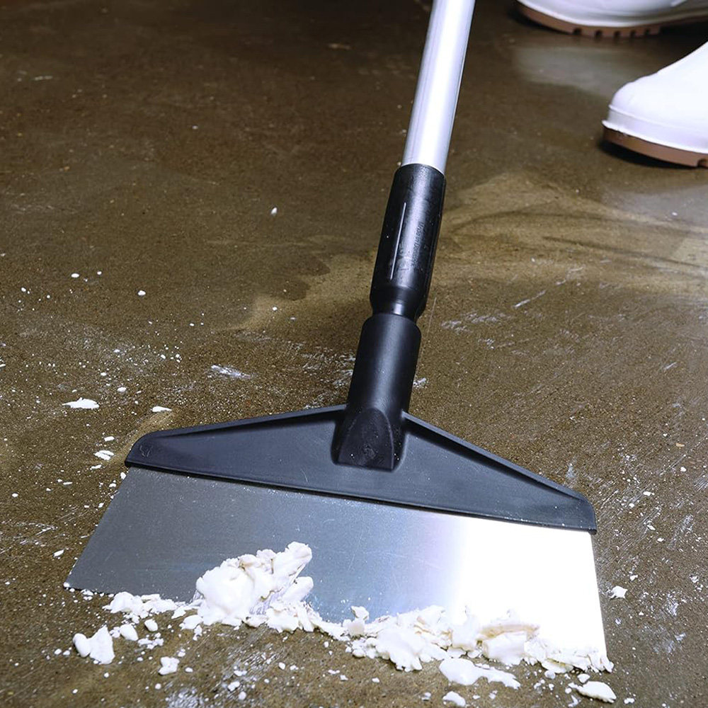 Black Vikan scraper with stainless steel blade, ideal for removing stubborn dirt and food residues from industrial floors.
